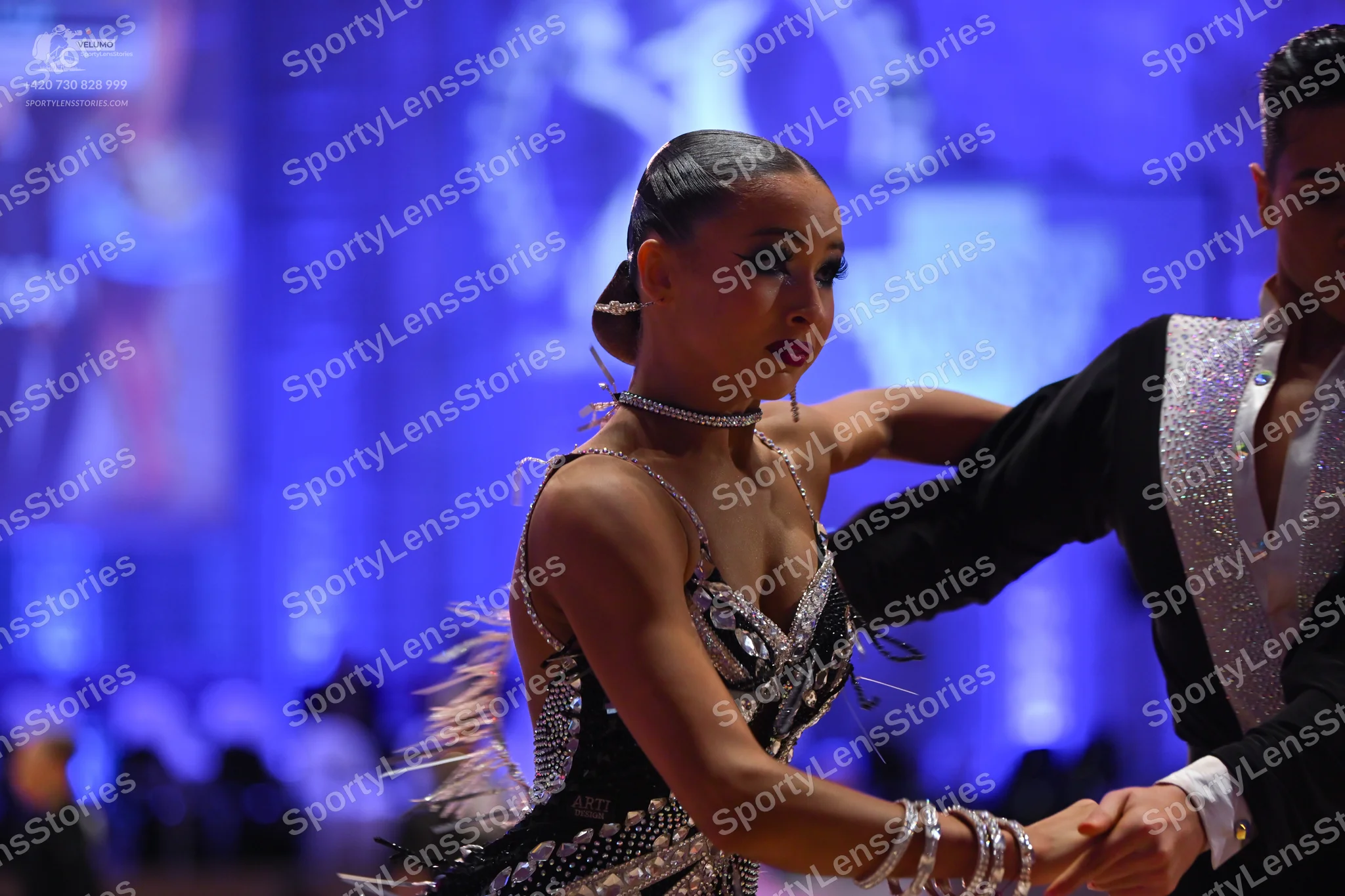 Dancesport competitor: Female dancer: black latin dress with silver sequins, featuring thin straps and