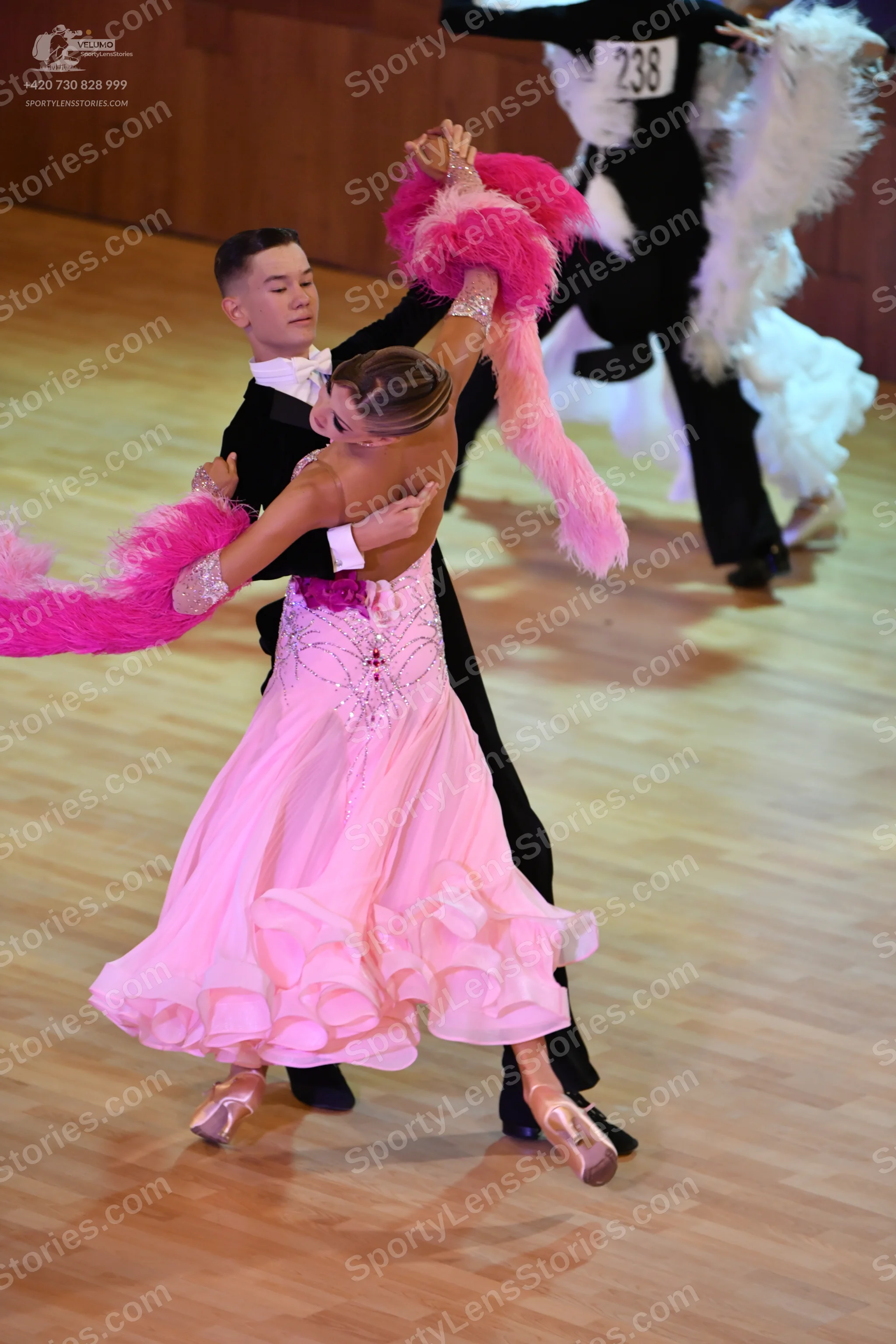 Dancesport competitor: ** Pink, shimmering, floor-length Latin dress