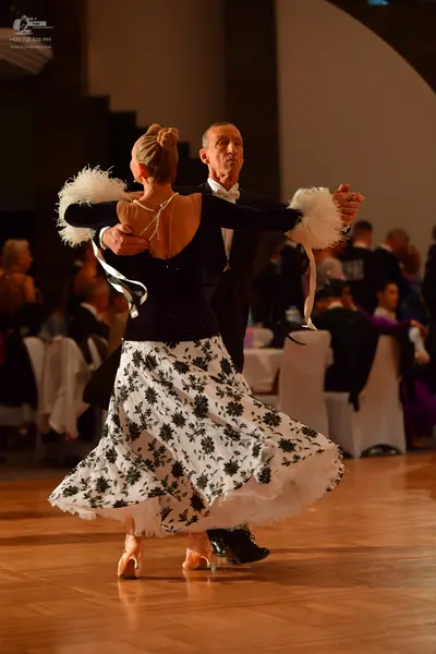Dancesport competitor: Male dancer: black suit, white shirt, and white bowtie