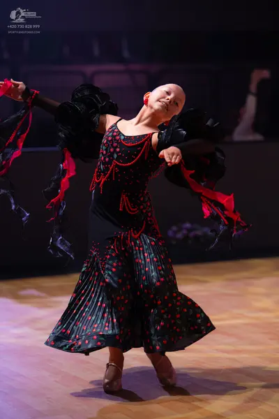 Dancesport competitor: Female dancer: black and red long ballroom dress with large, puffy, tiered black