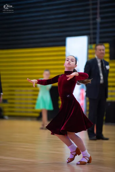 Dancesport competitor: Male:** Black tailsuit with sequin lapels