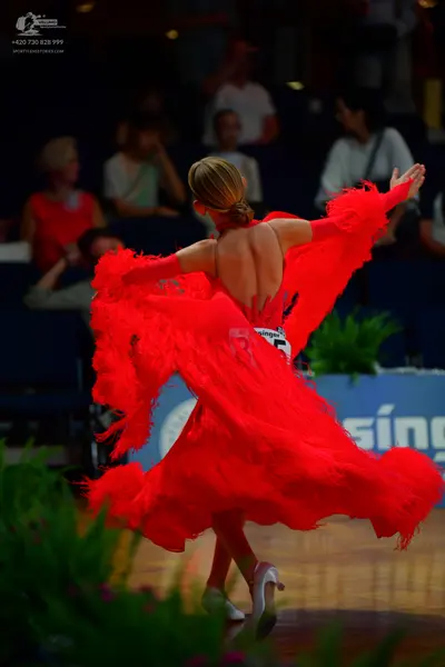 Dancesport competitor: Female dancer: red Latin dance dress with fringe