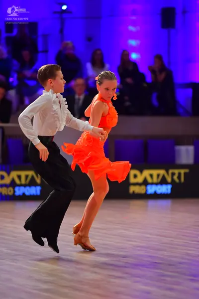 Dancesport competitor: Male dancer: white long-sleeved shirt with ruffles and black trousers
