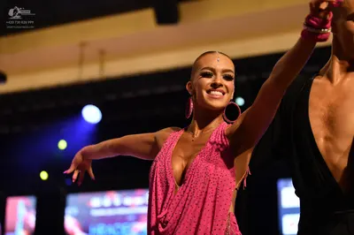 Dancesport competitor: ** Pink, shimmering, form-fitting latin dress