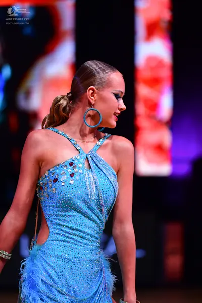 Dancesport competitor: Female dancer: light blue sequined latin dress with a halter neckline, side cuto