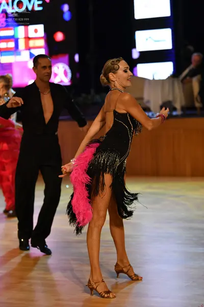 Dancesport competitor: Male dancer: black long-sleeved shirt and black trousers