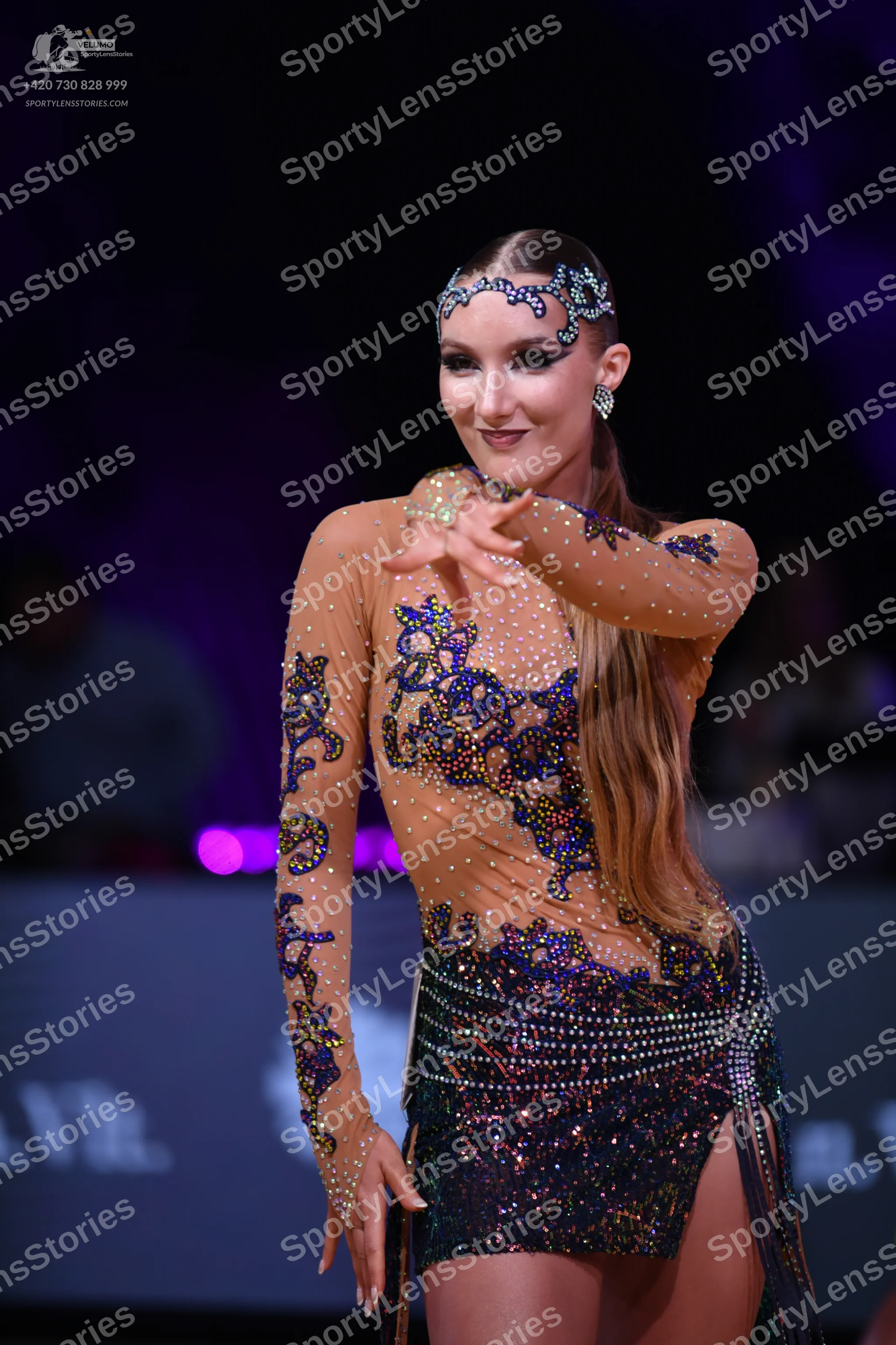 Dancesport competitor: Female dancer: nude-colored long-sleeved Latin dance dress with blue and purple