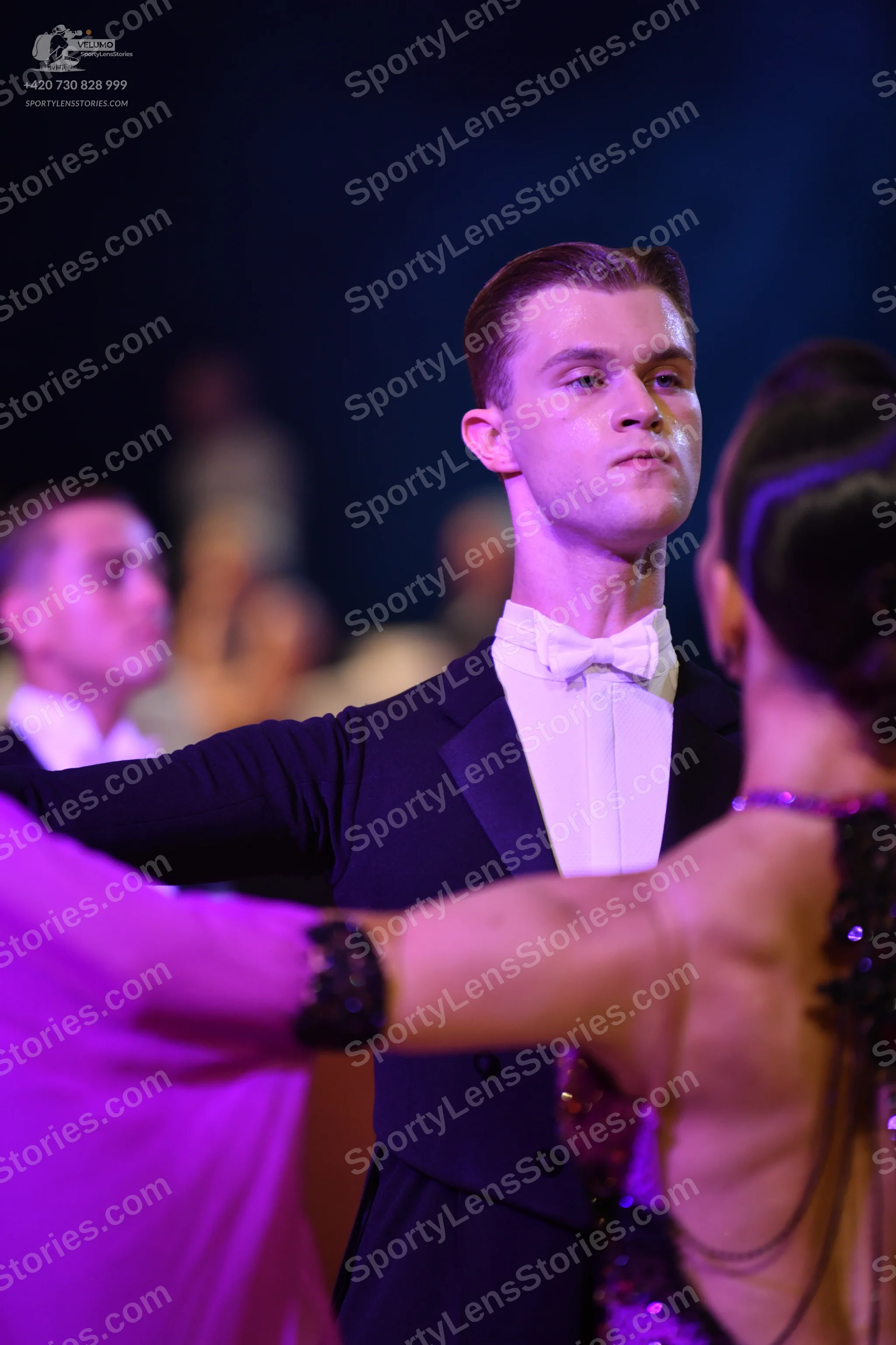 Dancesport competitor: Male dancer: black suit with white shirt and white bow tie