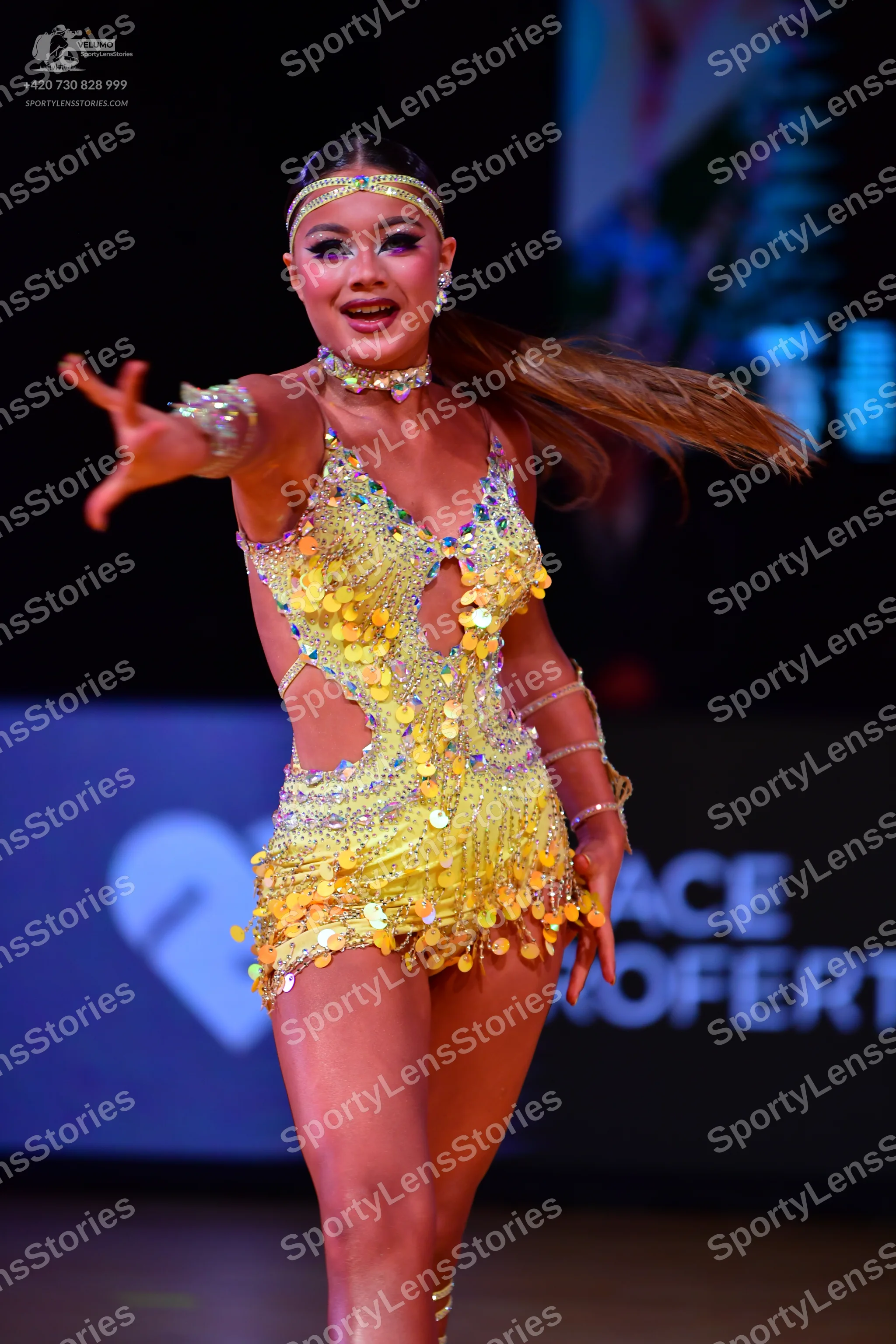 Dancesport competitor: Female dancer: yellow latin dress covered in sequins and large paillettes with s