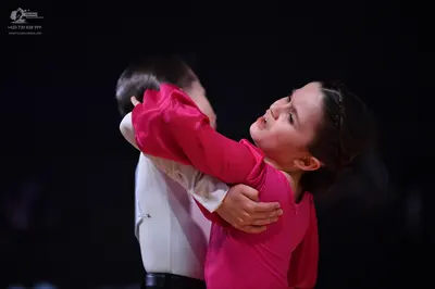 Dancesport competitor: Male dancer: white long-sleeved shirt and black belt