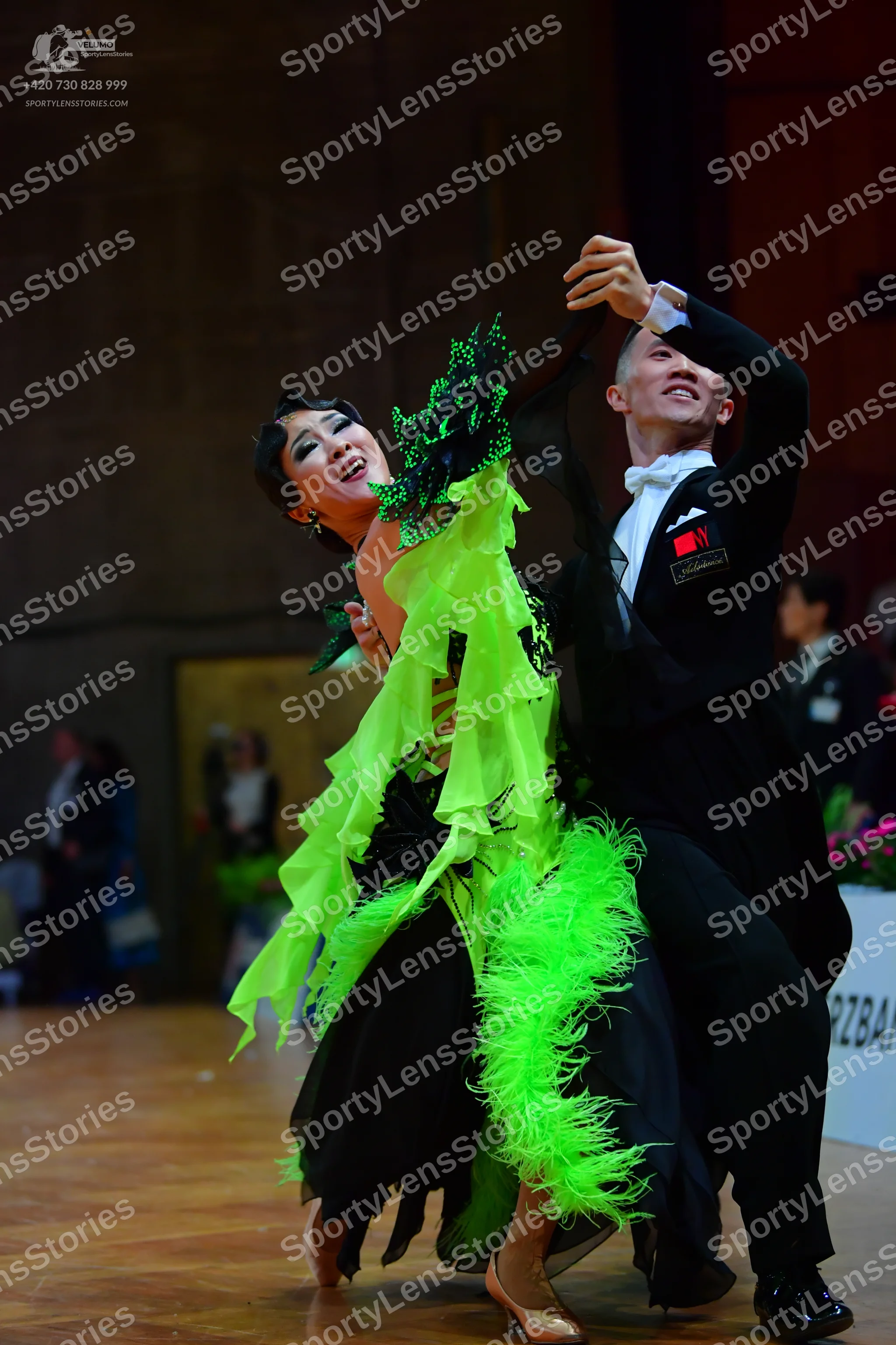 Dancesport competitor: Male dancer: black suit with white shirt, white bowtie, and white pocket square