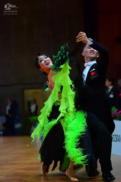 Dancesport competitor: Male dancer: black suit with white shirt, white bowtie, and white pocket square