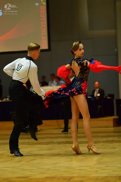 Dancesport competitor: Male dancer: white long-sleeved shirt with black collar and black trousers