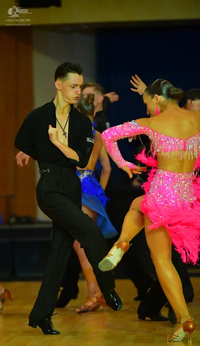 Dancesport competitor: Male dancer: black long-sleeved shirt and black trousers