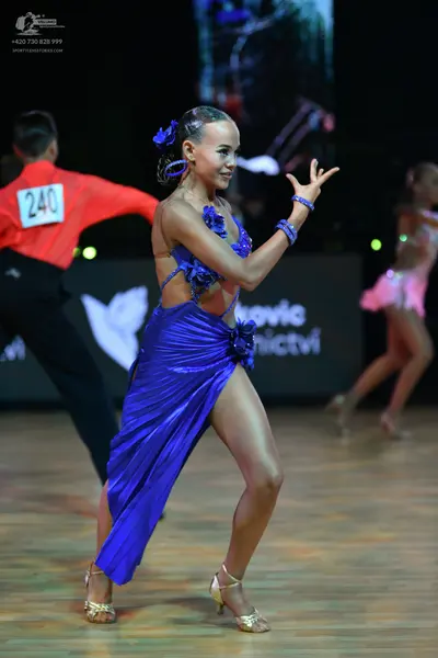 Dancesport competitor: Male dancer: red long-sleeved shirt and black trousers