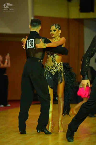 Dancesport competitor #128: Male dancer: black long-sleeved shirt with a sheer mesh back and black trousers