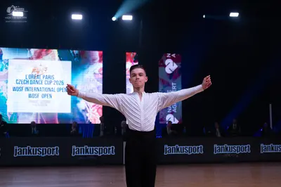 Dancesport competitor: Male dancer: white long-sleeved shirt with vertical pleats and black trousers