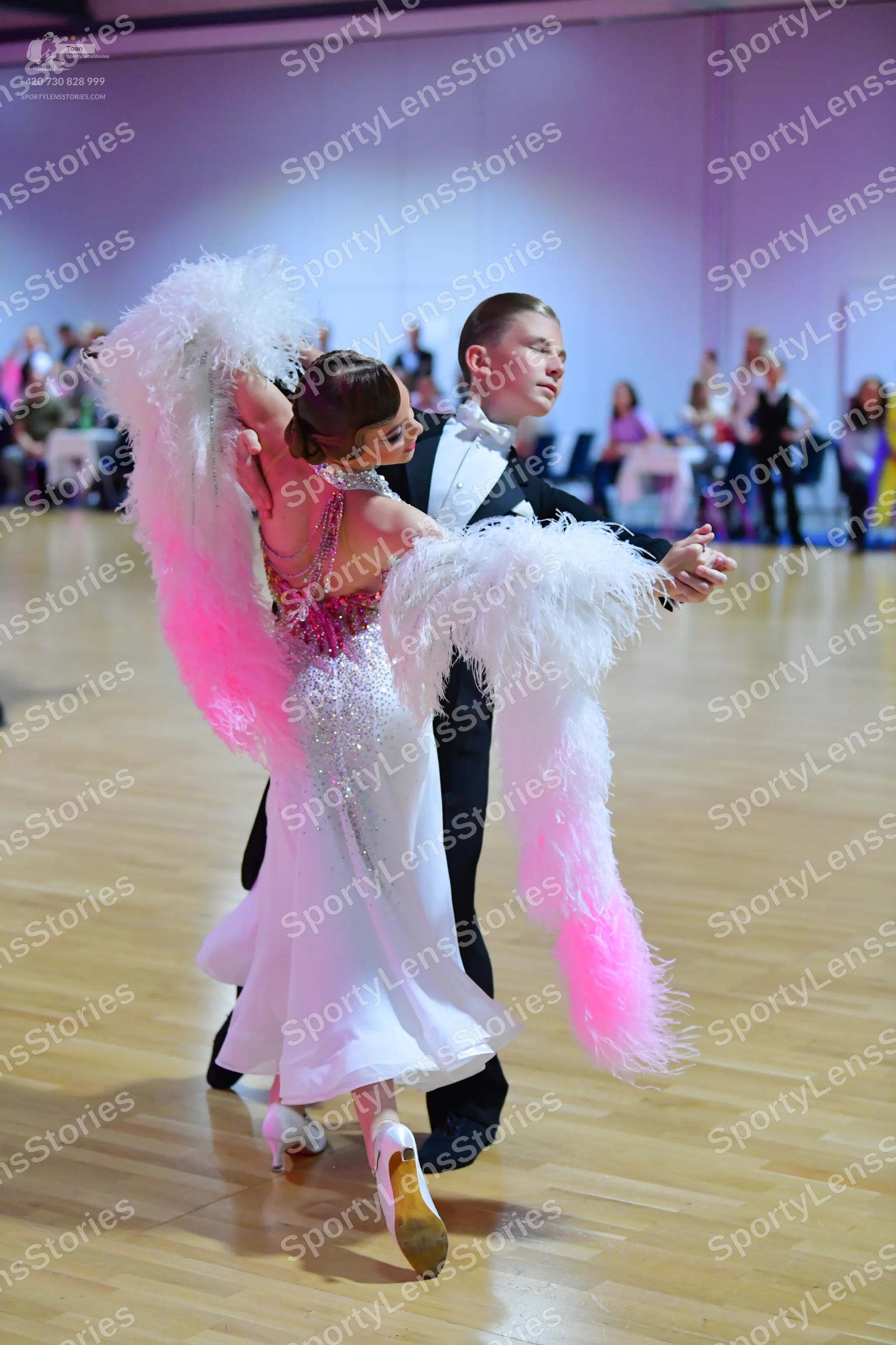 Dancesport competitor: Male dancer: black tuxedo with a white shirt and a white bowtie