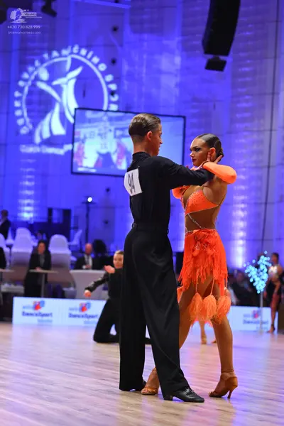Dancesport competitor: Male dancer: black long-sleeved shirt and black trousers