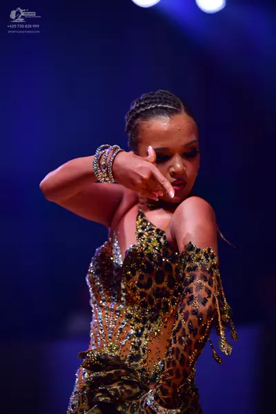 Dancesport competitor: Female dancer: leopard print latin dress with long sleeves, embellished with seq
