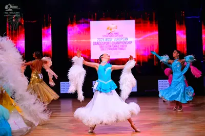 Dancesport competitor: Dancer in gold: gold-colored ballroom gown with a long, flowing skirt