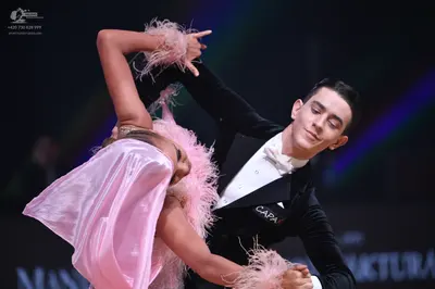 Dancesport competitor: Male dancer: black suit, white shirt, and white bowtie
