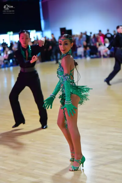 Dancesport competitor: Male dancer: black latin dance shirt with green sequin details and black trouser