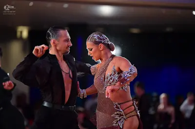Dancesport competitor: Male dancer: black long-sleeved latin dance shirt, open at the chest, with black