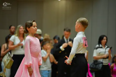 Dancesport competitor #21: Female dancer: light pink, long-sleeved, flowing ballroom dress