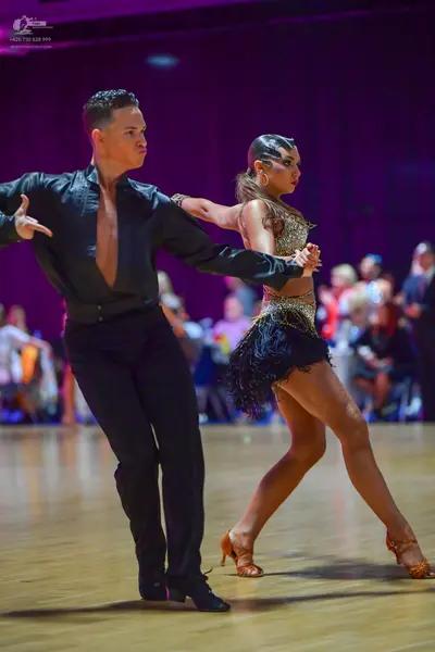 Dancesport competitor: Male dancer: black long-sleeved shirt and black trousers