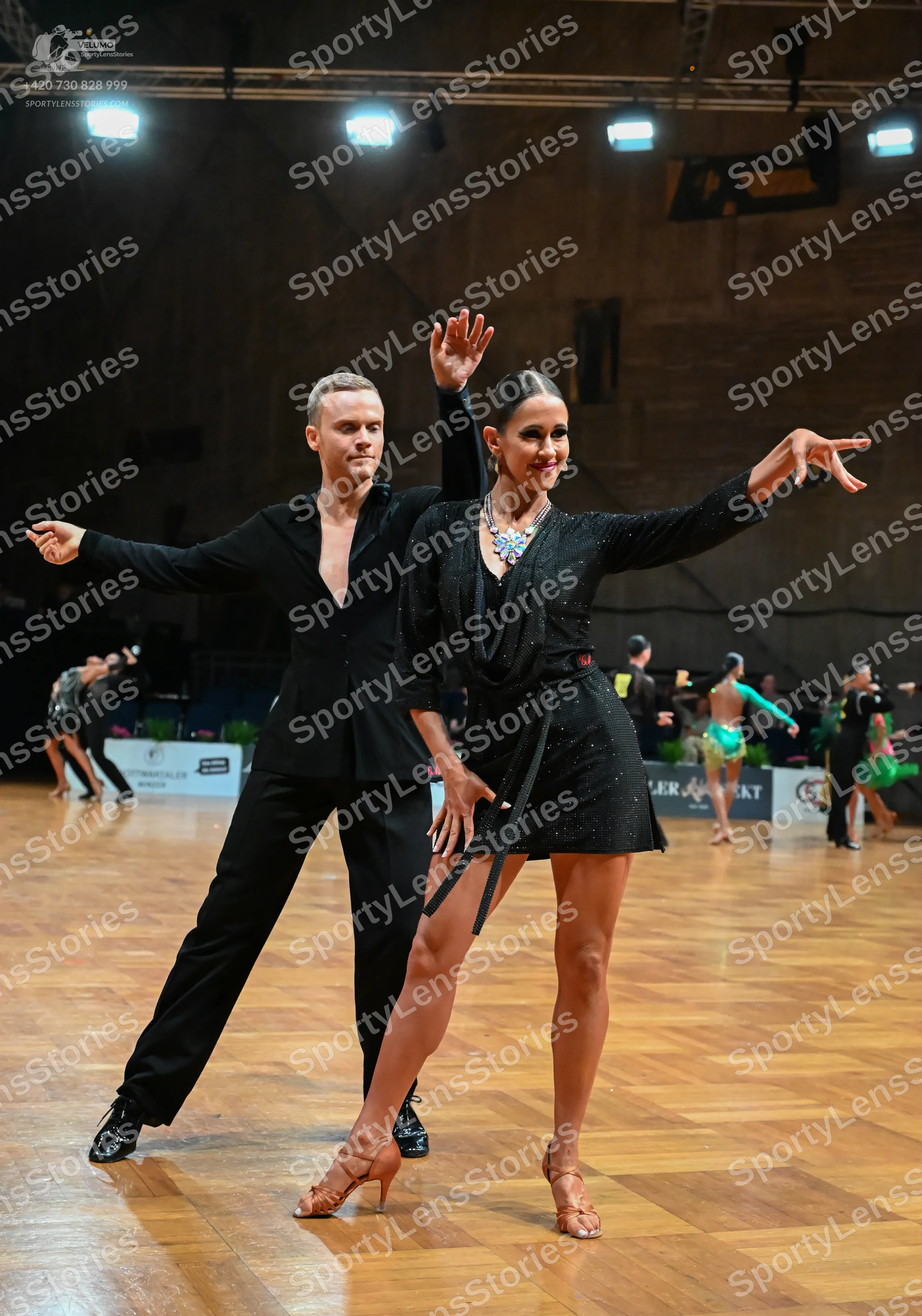 Dancesport competitor: Male dancer: black suit with a black shirt and black trousers