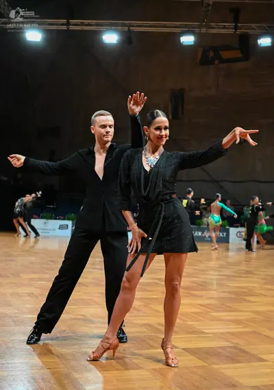 Dancesport competitor: Male dancer: black suit with a black shirt and black trousers