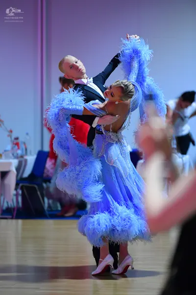 Dancesport competitor: Male dancer: black suit with a white shirt and white bow tie