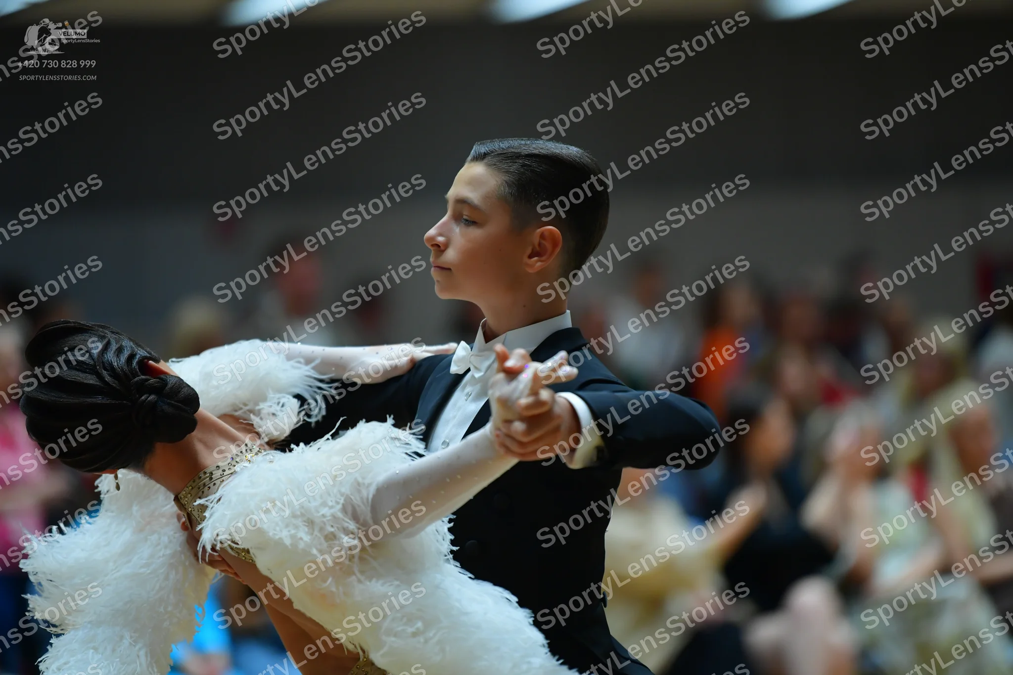Dancesport competitor: Male dancer: black suit with a white shirt and white bow tie