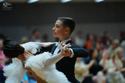 Dancesport competitor: Male dancer: black suit with a white shirt and white bow tie
