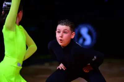 Dancesport competitor: Female dancer: neon yellow long-sleeved bodysuit