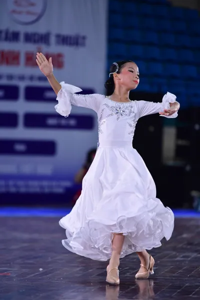Dancesport competitor: Female**
*   **Color:** White
*   **Fabric:** Primarily satin, heavily embellish