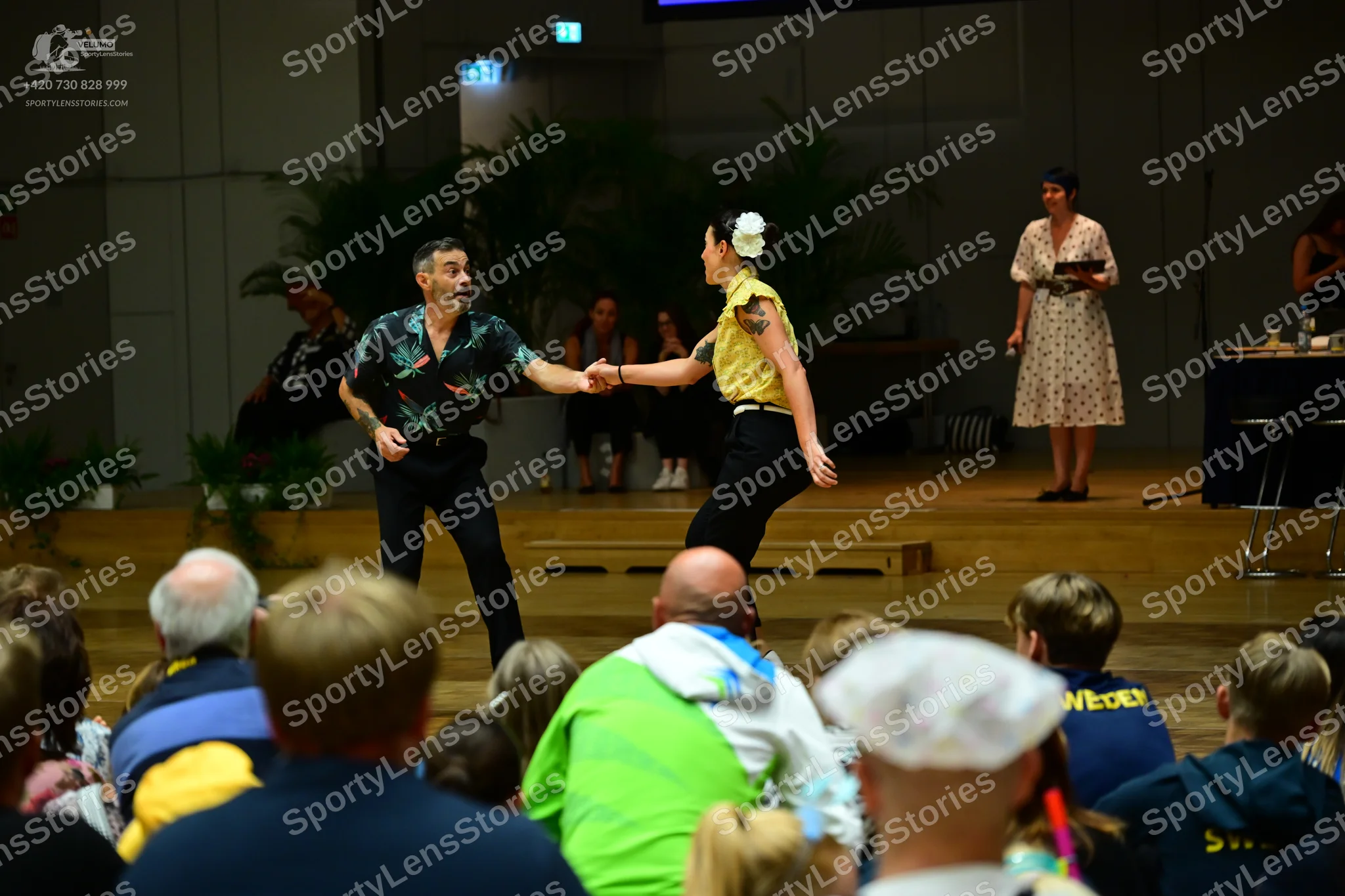 Dancesport competitor: Male dancer: dark patterned short-sleeved shirt and black trousers