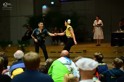 Dancesport competitor: Male dancer: dark patterned short-sleeved shirt and black trousers