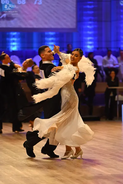 Dancesport competitor: Male dancer: black suit with a white shirt
