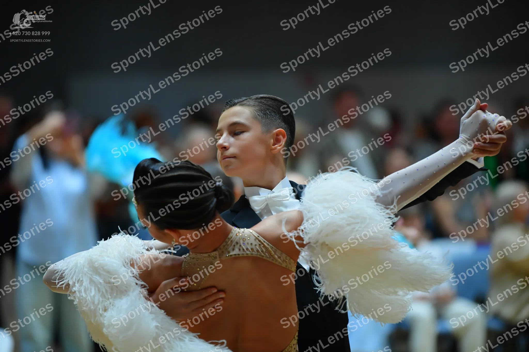 Dancesport competitor: Male dancer: black suit with a white shirt and white bow tie