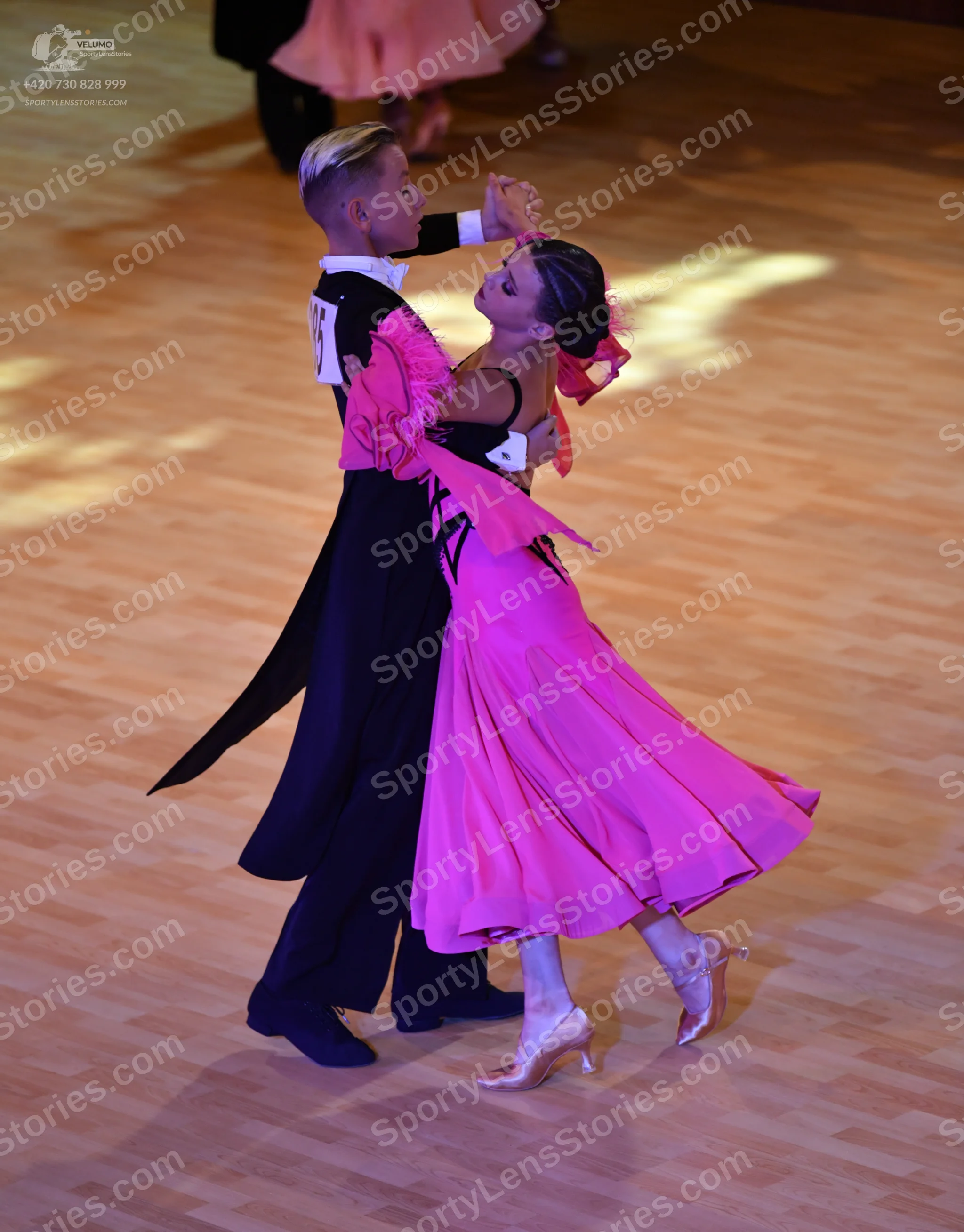 Dancesport competitor: Male:** Black tail suit with black sequin lapels and a black tie