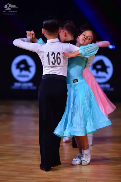 Dancesport competitor: Male dancer: white long-sleeved shirt and black trousers