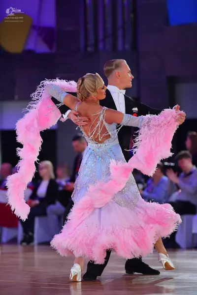 Dancesport competitor: Male dancer: black tuxedo with a white shirt and black bowtie