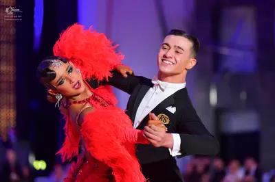 Dancesport competitor: Male dancer: black suit with a white shirt and white bowtie