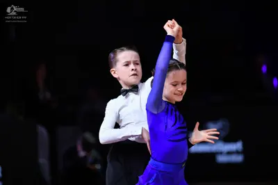 Dancesport competitor: Male dancer: white long-sleeved shirt, black bow tie, and black trousers