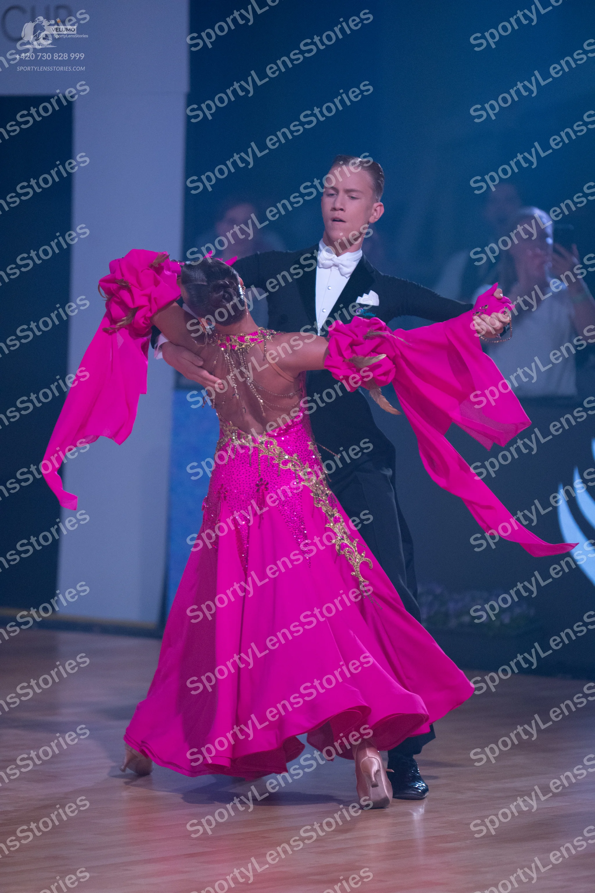 Dancesport competitor: Male dancer: black suit with a white shirt, white bowtie, and a white pocket squ