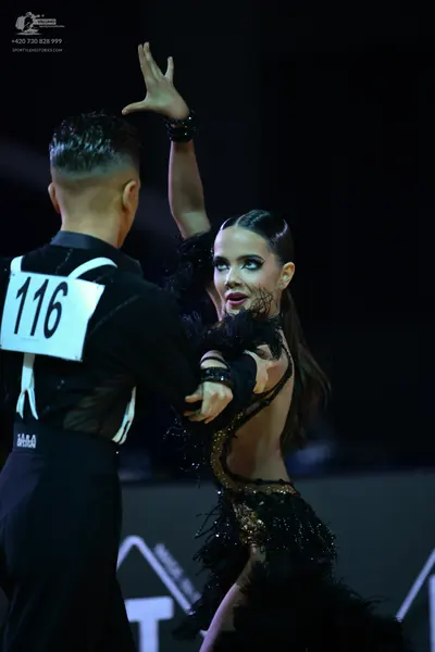 Dancesport competitor: Male dancer: black shirt with white patterned design and black trousers