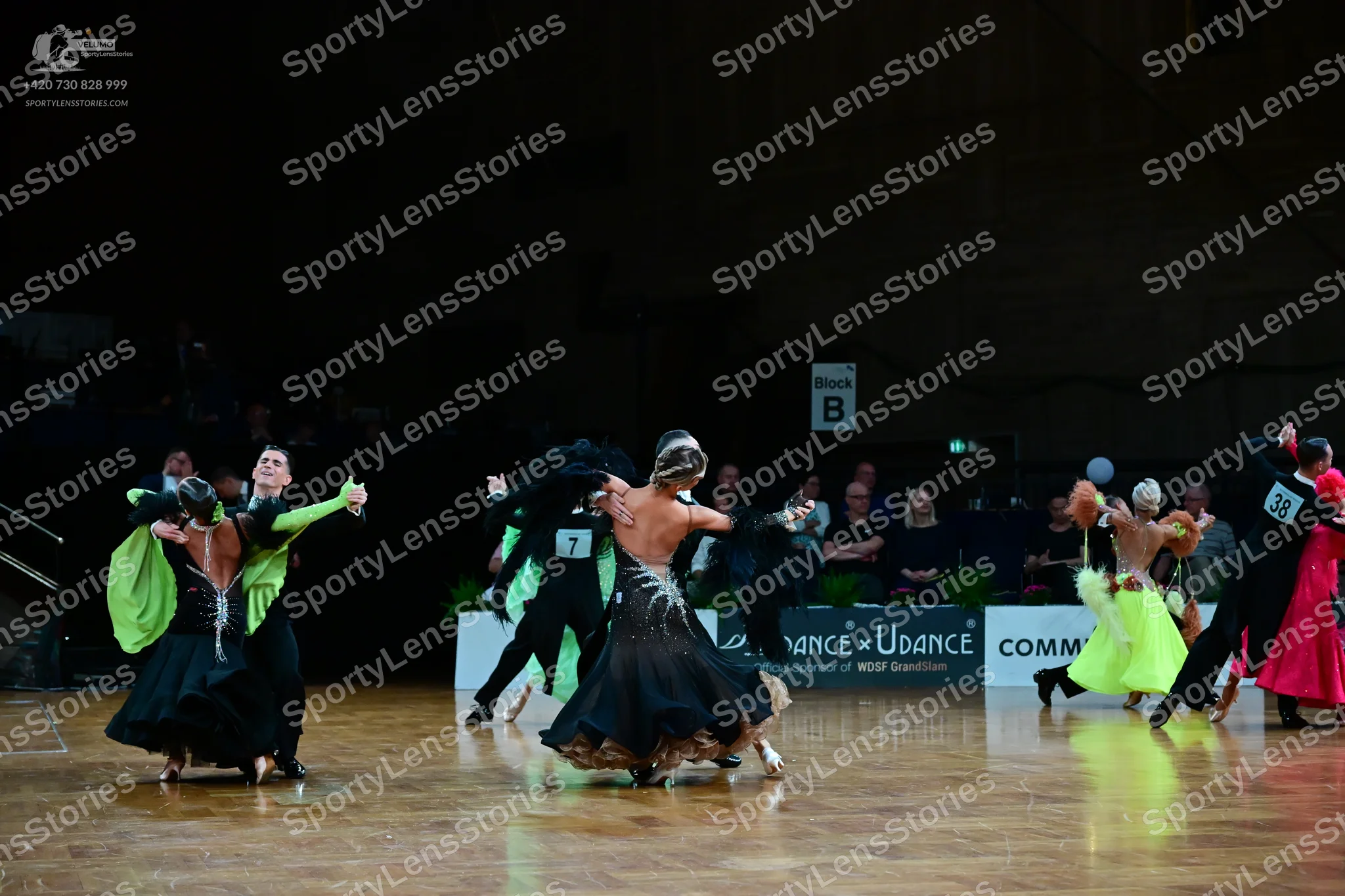 Dancesport competitor #38: First pair: Female dancer in a black ballgown with lime green sleeves; male danc