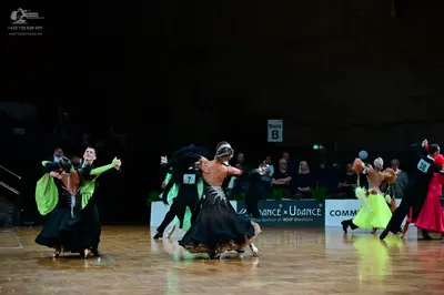 Dancesport competitor #38: First pair: Female dancer in a black ballgown with lime green sleeves; male danc